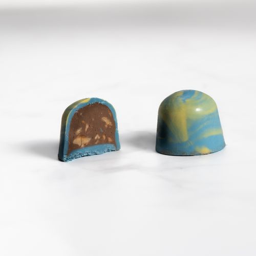 Gianduja cream with crushed hazelnut in colored chocolate